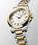 Longines Conquest L3.460.3.12.7 Swiss Made 34 mm quartz watch with a white sandblasted dial, stainless steel case with yellow gold PVD bezel, and stainless steel bracelet with yellow gold PVD centre links.