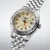 Seiko 5 Sports Field GMT HDB002 39.4mm automatic watch with beige dial, orange GMT hand, stainless steel case and stainless steel bracelet.
