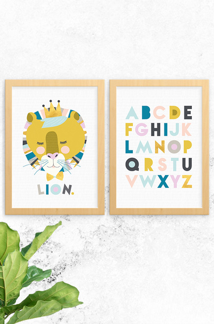 Luca Rose Designs 2 pack print set showing Lenni Lion print on the left and the Alphabet print on the right. Both have an oak frame and light grey background. The colour combinations are pastel, mustard and gold.