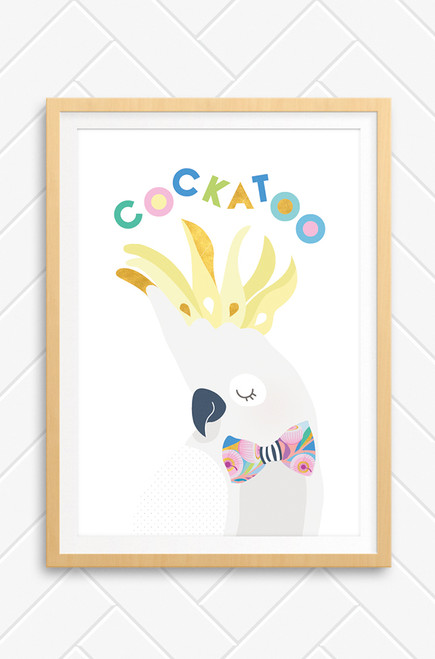 A delightful cockatoo illustration filled with yellows, pinks, light greys and white. A simple artwork perfect for a child's bedroom or nursery. The bird wears a bright bowtie and it's crest is standing tall. The word Cockatoo is playfully arranged above it's head. 
