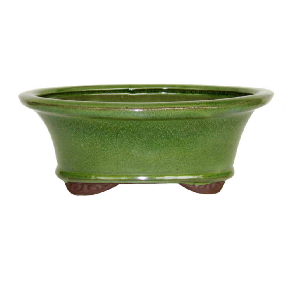 a green bowl with brown legs