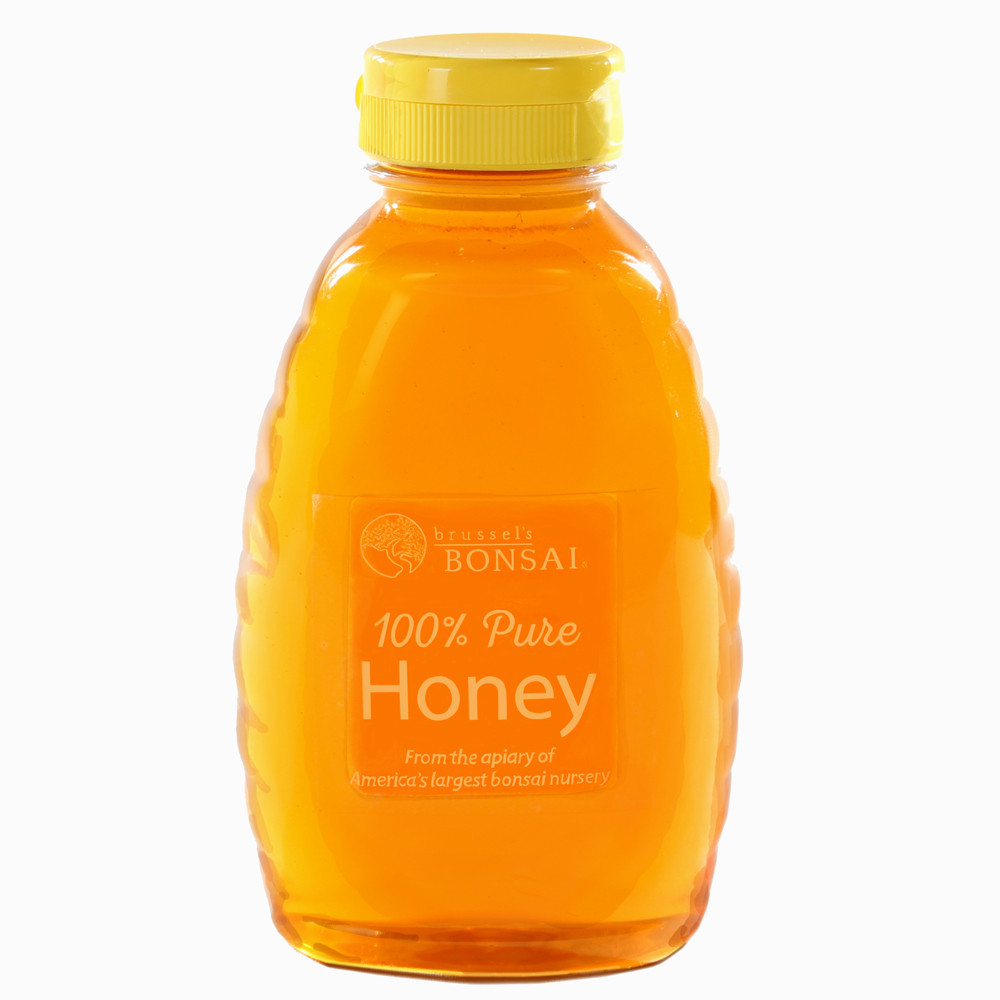 a bottle of honey with a yellow cap