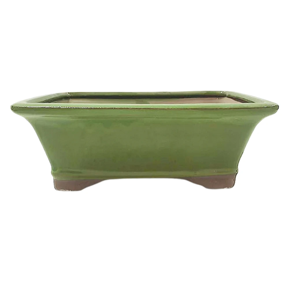 a green rectangular pot with a brown bottom