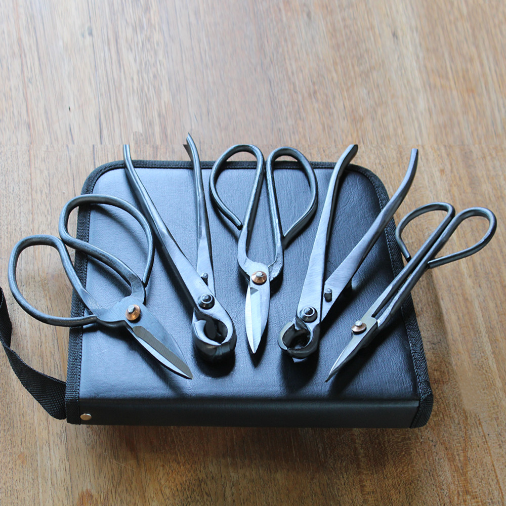 a group of scissors and a bag