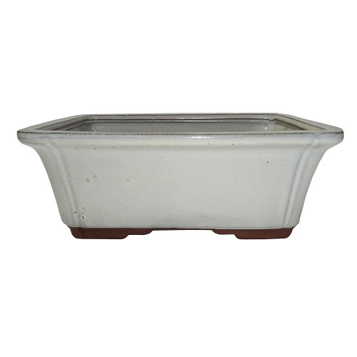 a white rectangular pot with brown legs