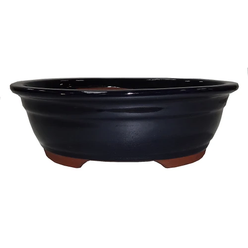 a black bowl with brown legs