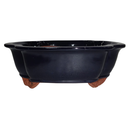 a black bowl with brown legs