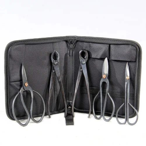 A black case containing a pair of scissors and additional scissors inside
