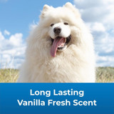 A fluffy white Samoyed dog smiles outdoors under a blue sky. Text reads 'Long Lasting Vanilla Fresh Scent.'