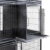 Close-up of DuraDog Economy 6-Cage Bank STD, shown with door opened and divider and pan extended