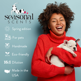 Smiling woman in a red sweater holding a sleeping French Bulldog puppy, alongside the Seasonal Scents logo and product features: spring edition, for pets, handmade, eco-friendly, 16 to 1 dilution and made in the USA