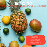Fresh fruits on a blue background overlaid with text reading 'enticing fragrance to awaken your senses, mango pineapple fragrance'