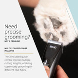 Wahl Fidela Cordless Trimmer shown in use on a dog’s paw pad, highlighting three included guide combs for precise grooming