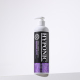 Bottle of Grooming Artist Hand Scissoring & Volume Shampoo on a clean, minimal background with soft shadow
