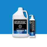 Product image of Grooming Artist Deep Cleanse & Volume Shampoo in 3.8 L and 530 mL sizes against a blue background