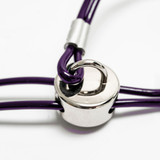 Close-up of the Trach Saver® purple grooming restraint showing the stainless steel D-ring and sliding adjuster for secure, low-pressure pet restraint during grooming.