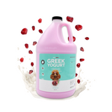 Gallon jug of Bark2Basics Pomegranate Greek Yogurt Shampoo, displayed with fresh pomegranates and cream