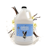 Gallon jug of Bark2Basics Vanilla Greek Yogurt Shampoo, surrounded by vanilla pods and fresh cream
