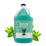 Gallon jug of Bark2Basics Skin Remedy Shampoo, surrounded by fresh spearmint leaves