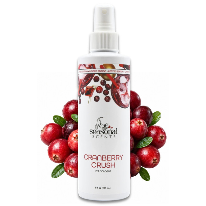 Front view of an 8 oz bottle of Seasonal Scents Cranberry Crush Cologne surrounded by fresh cranberries.