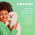 Woman holding a small white dog against a green background with Artero branding and text highlighting natural ingredients, environmentally friendly formula and no animal derived products