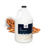 Gallon jug of Crown Coat Almond Grove All Purpose Conditioner, surrounded by whole almonds spilling from a white bowl