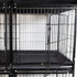 Close-up of interior of DuraDog Economy 6-Cage Bank STD, shown with divider and pan inserted and door opened