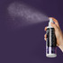 Hand spraying HYPONIC Grooming Artist Detangling Mist against a purple background, showing the fine mist application