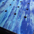 Close-up of the blue side of SpawMat placed on a grooming table, showcasing light-flow holes, textured non-slip surface and embossed logo detail