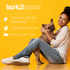 Smiling woman sitting on the floor holding a French Bulldog, with Bark2Basics branding and key product benefits: naturally derived ingredients, cruelty & soap free and made in the USA