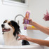 A black and white dog is picturedin a bathtub. A womans hands are shown squeezing Bio-Groom Silk into her hands to give the dog a bath.
