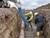 Construction works using a Poly Concrete Hopper with Pipe and 5' Blue Elephant Trunk in  the ground with pipe lines.