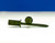Two reusable green Little Johnson concrete form screws stacked in a cross formation on a white background.