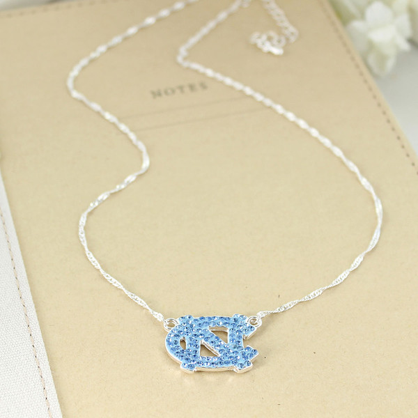 Carolina Blue rhinestones in shape of interlocking NC on silver necklace
