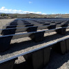 Rows of panels mounted on Powerfield PowerRacks on gravel 