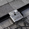 Close-up of SnapNrack solar mounting rail clamp with integrated bolt and channel slot