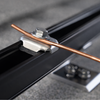 Close-up of SnapNrack solar mounting rail clamp with integrated bolt and channel slot