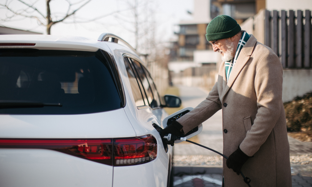 Sailboat on ocean with people setting up the sails.