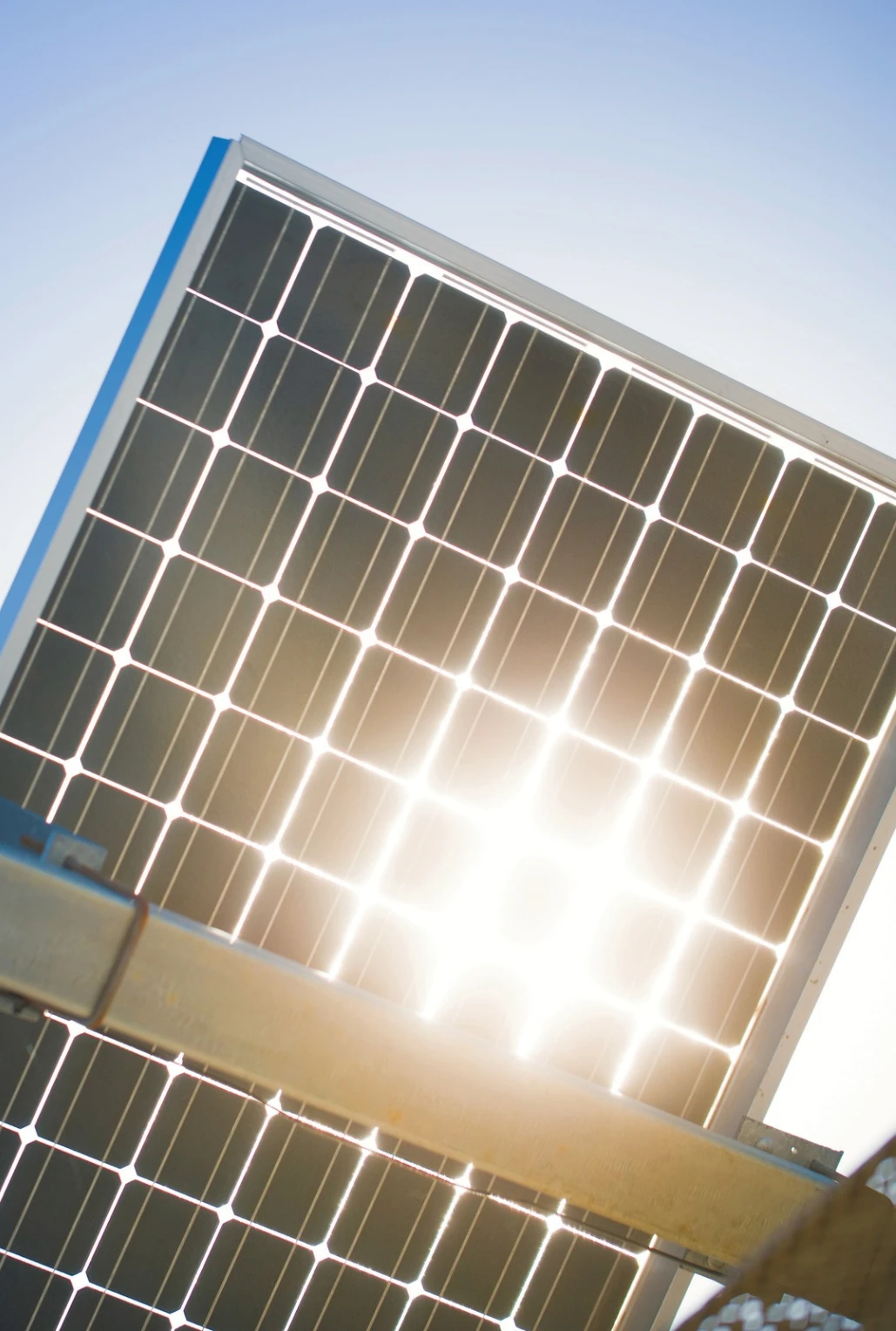 Solar panel with sun coming through.
