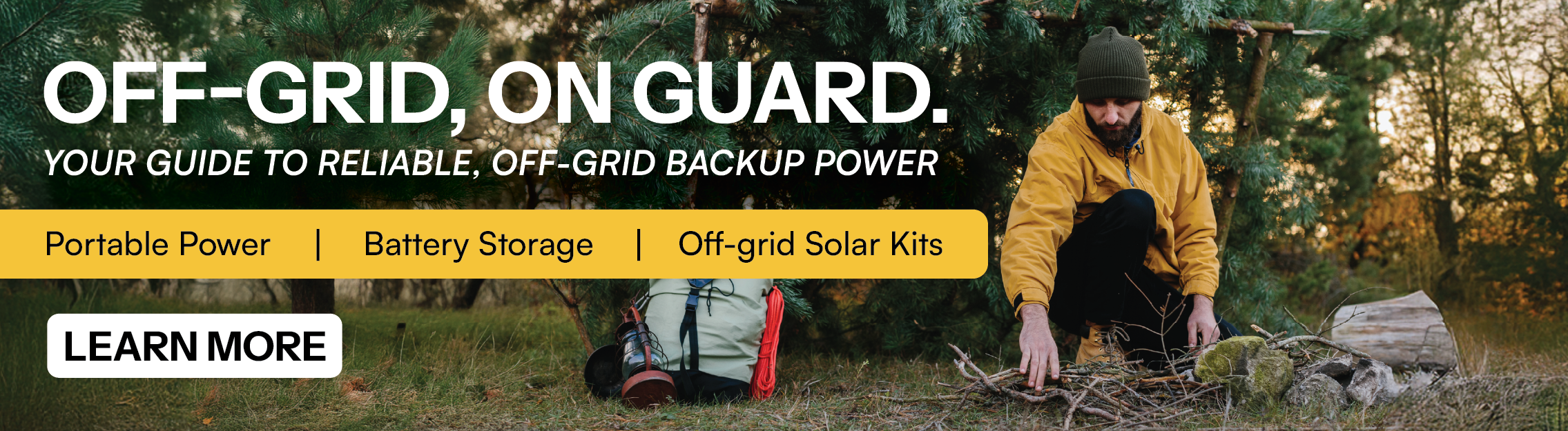 Man in the woods making fire with backpack and gear. Learn more about off-grid power.