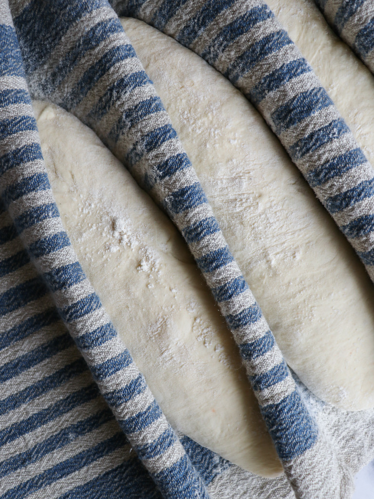 Blue striped linen with floured sourdough loaves resting best linen quality lithuanian