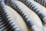 Baguettes in heavy blue linen couche proofing cloth resting dough