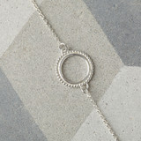 delicate halo design bracelet in sterling silver. circle design with beaded detail on a fine belcher chain.