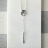 Necklace with drop and bar. Dappled silver disc with suspended bar of silver.