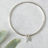 Solid silver bangle with leaf charm.