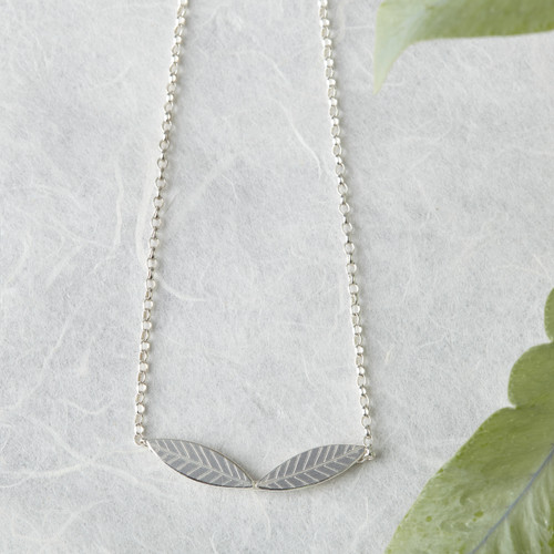 Delicate handmade silver necklace with wreath design. Two leaves that join in the centre.
