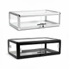 Two aluminum countertop display cases with glass panels and locks, one silver-framed and one black-framed.