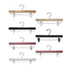 Assorted wooden pant and skirt hangers in natural, black, white, and cherry finishes with metal clips