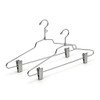 Two chrome wire hangers shown with looped and plain hooks, each with sliding adjustable clips for pants or skirts