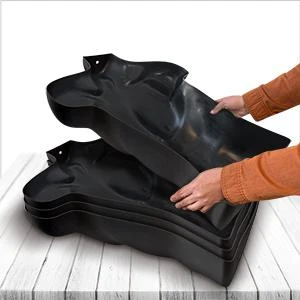 Several black torso mannequins stacked into each other for storage